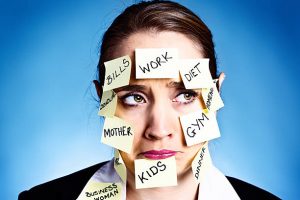 Woman covered with reminders for all sorts of tasks pouts.